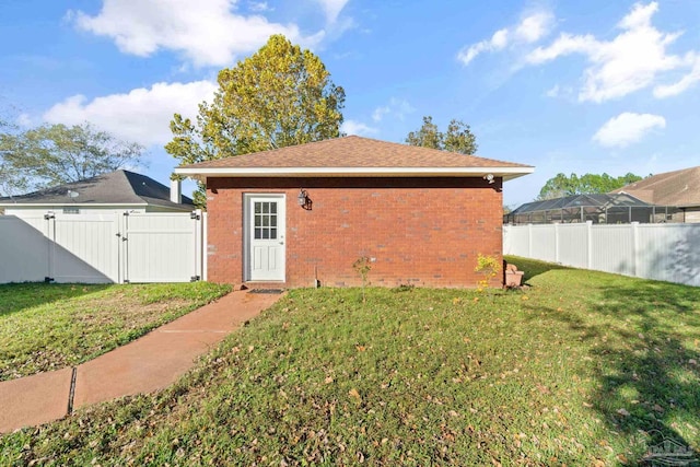 view of outbuilding with a lawn