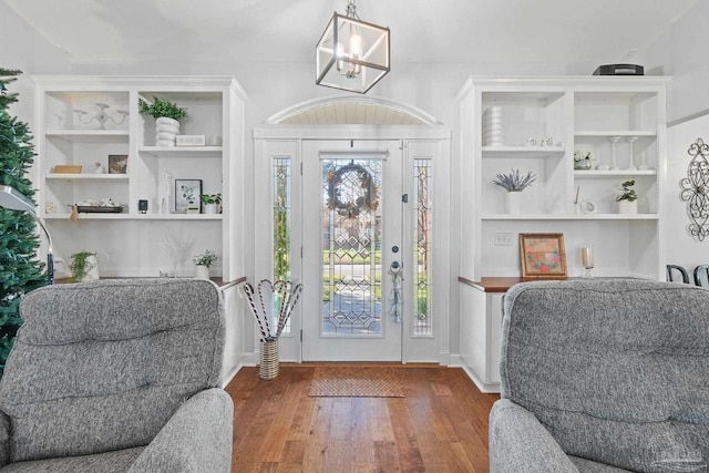 entrance foyer featuring a notable chandelier and dark hardwood / wood-style floors