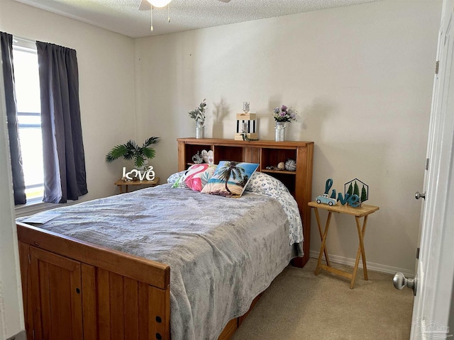 bedroom featuring light colored carpet and baseboards