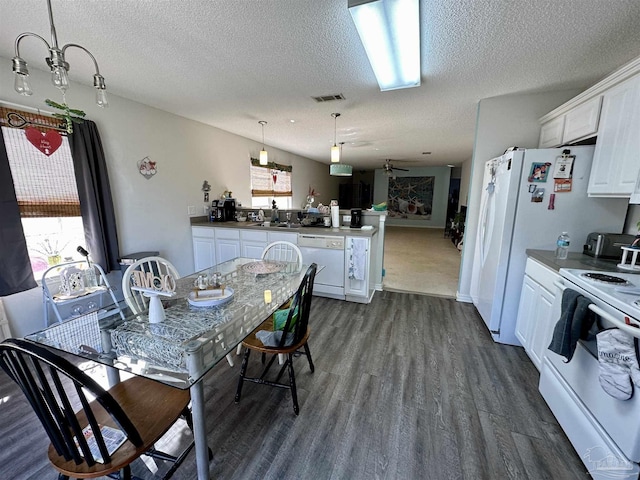 dining area featuring a textured ceiling, dark wood finished floors, and healthy amount of natural light