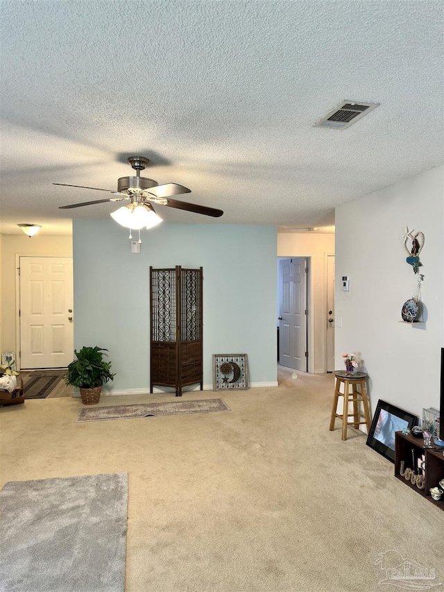 carpeted living room with ceiling fan and baseboards