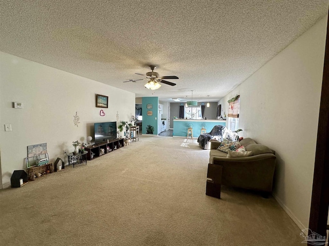 carpeted living room with a ceiling fan and a textured ceiling