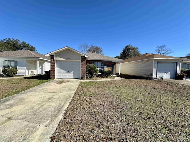 ranch-style home featuring a garage, driveway, brick siding, and a front lawn
