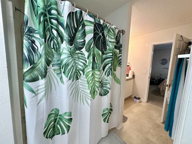 full bathroom with a textured ceiling and a shower with curtain