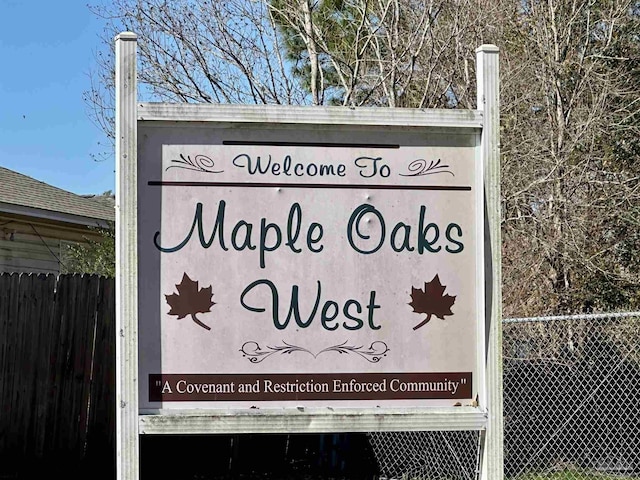 community sign with fence