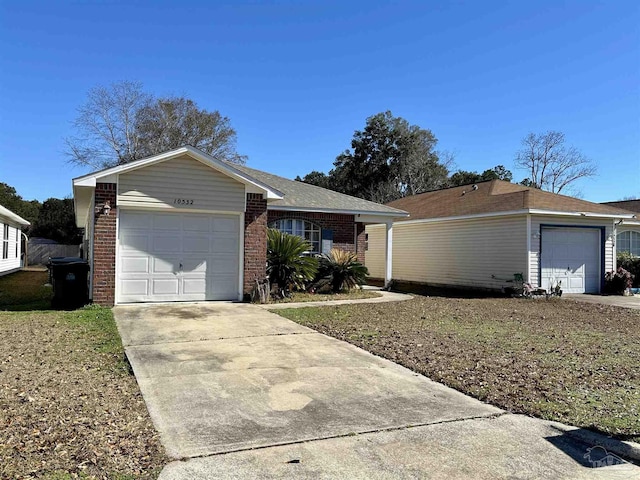single story home with brick siding, an attached garage, and driveway