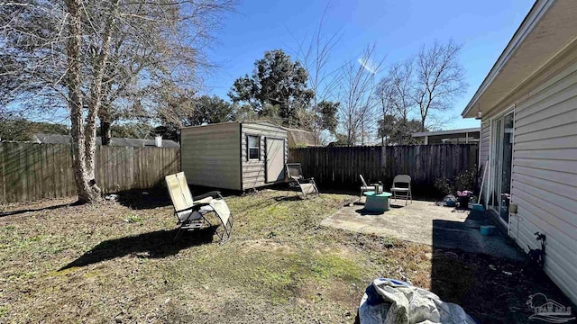 fenced backyard featuring a storage unit, an outbuilding, and a patio