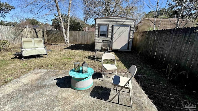 fenced backyard with an outbuilding, a shed, and a patio area