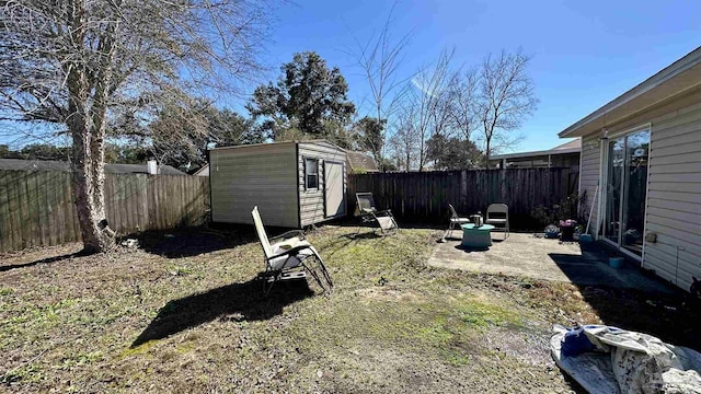 fenced backyard featuring an outdoor structure and a storage unit
