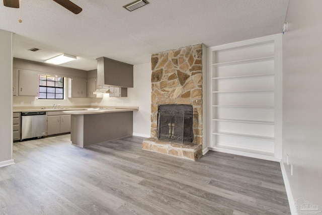 kitchen with visible vents, dishwasher, a textured ceiling, and a sink