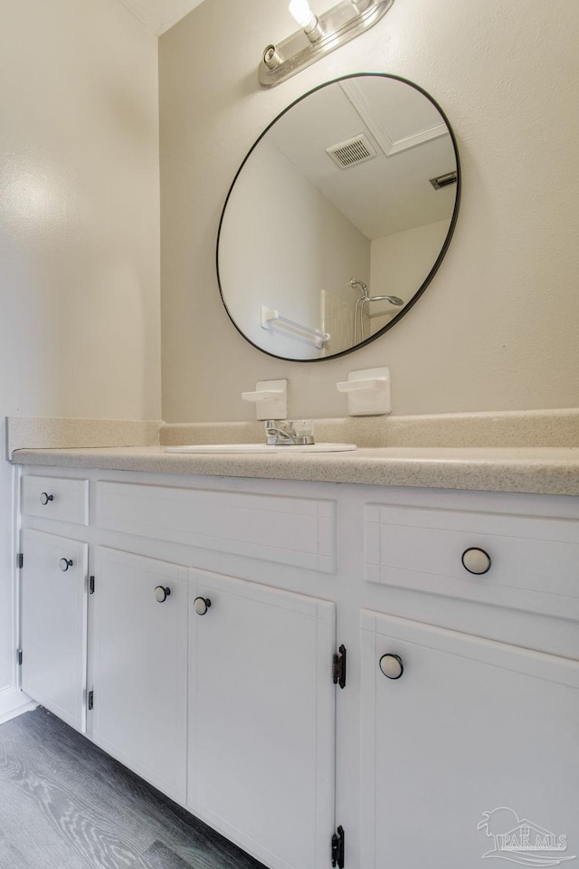 bathroom featuring visible vents, wood finished floors, and vanity