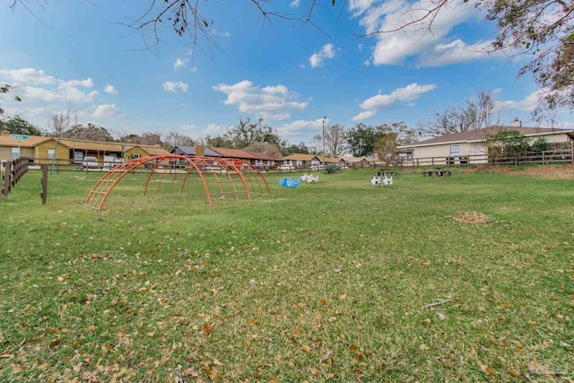 view of yard featuring fence and a playground