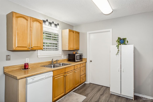 kitchen featuring dark hardwood / wood-style flooring, dishwasher, a textured ceiling, and sink