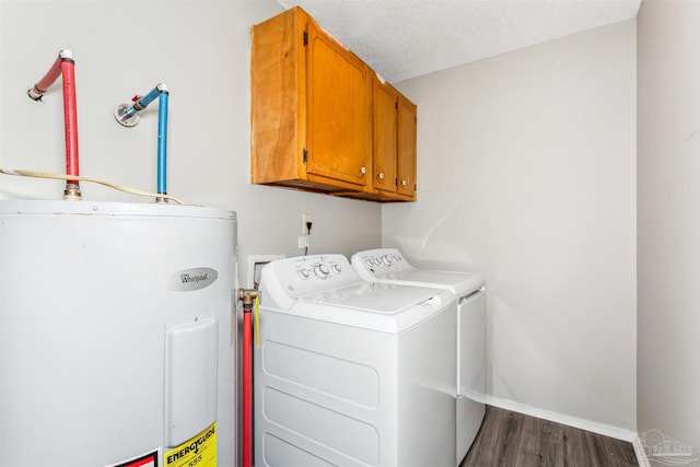 laundry area with dark wood-type flooring, cabinets, separate washer and dryer, electric water heater, and a textured ceiling