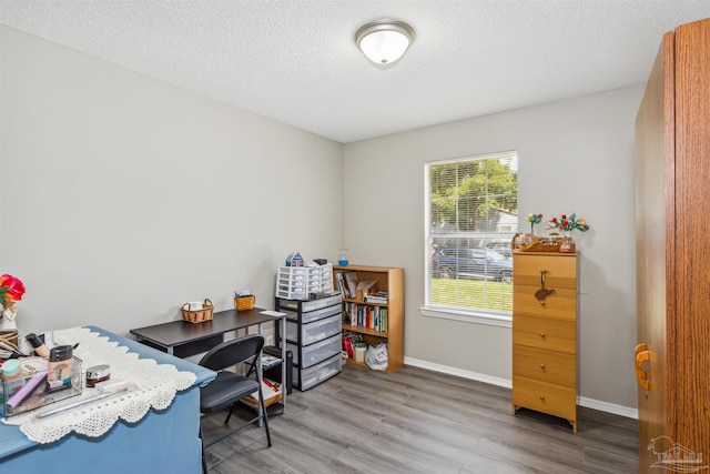 office with hardwood / wood-style floors and a textured ceiling