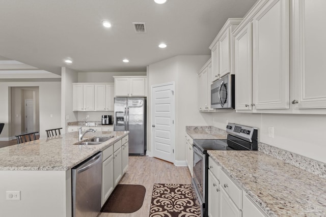 kitchen featuring visible vents, recessed lighting, a kitchen island with sink, a sink, and appliances with stainless steel finishes