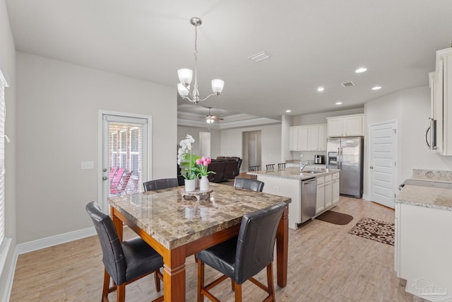 dining area featuring baseboards, visible vents, recessed lighting, ceiling fan with notable chandelier, and light wood-type flooring