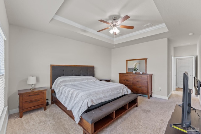 bedroom with visible vents, light colored carpet, baseboards, and a tray ceiling