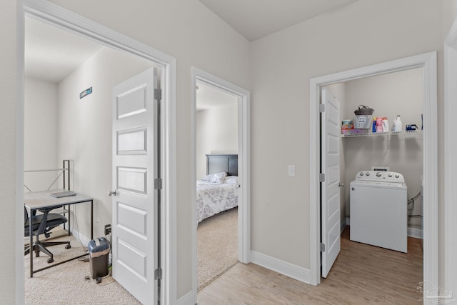 laundry room with baseboards, washer / dryer, wood finished floors, and laundry area