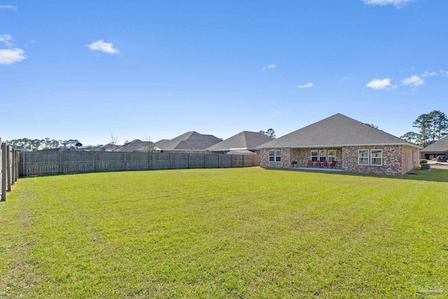 view of yard with a fenced backyard