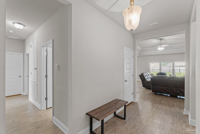 hallway featuring baseboards and light wood-type flooring