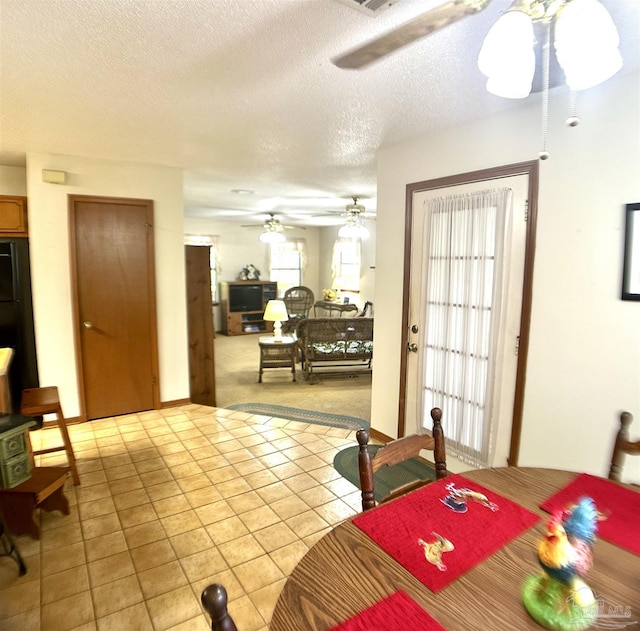 dining area featuring light tile patterned flooring and a textured ceiling