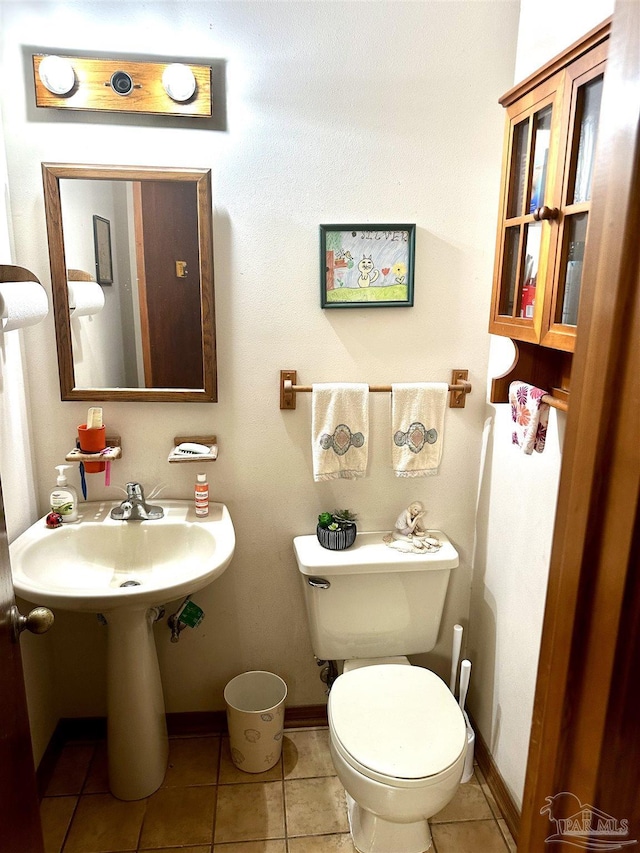 bathroom with tile patterned flooring and toilet