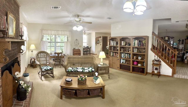 sitting room featuring a textured ceiling, carpet floors, ceiling fan with notable chandelier, and a brick fireplace