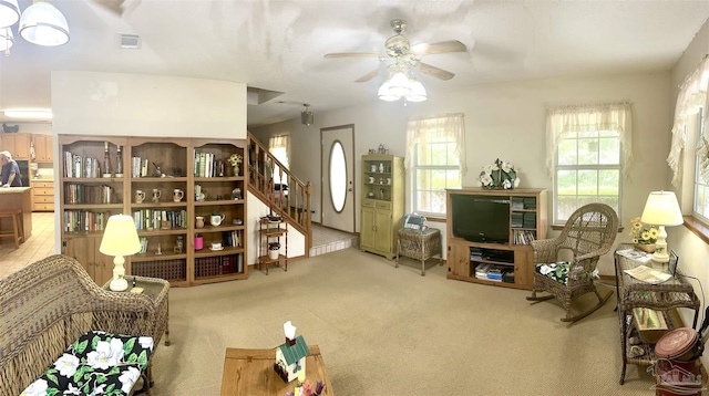 living area featuring ceiling fan and light colored carpet