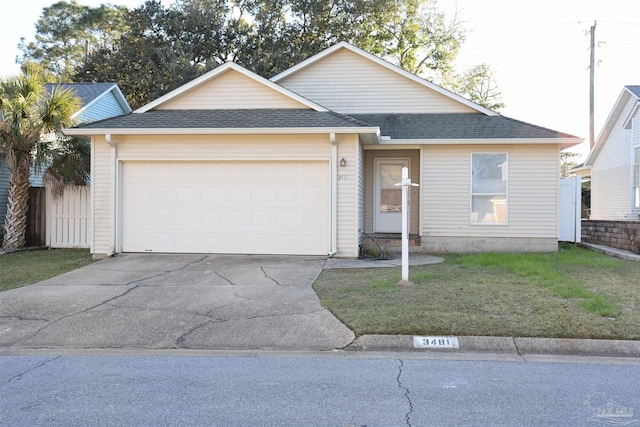 ranch-style home with a garage, a shingled roof, concrete driveway, and a front yard