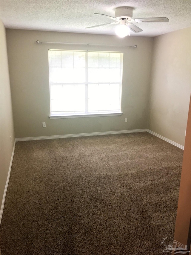 unfurnished room with a textured ceiling, baseboards, carpet floors, and ceiling fan