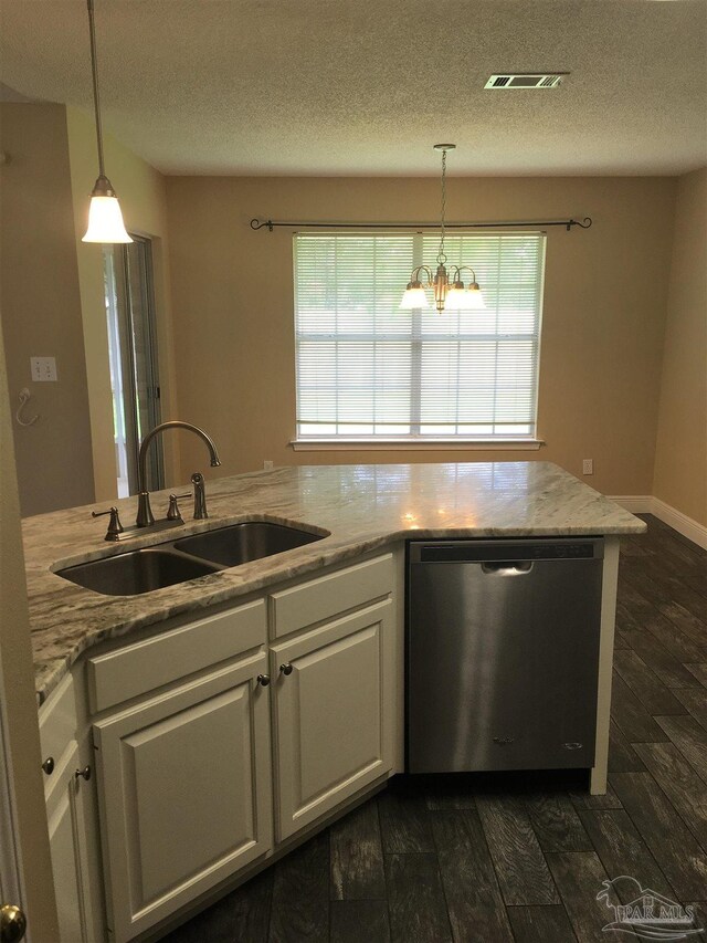 kitchen featuring visible vents, a sink, dark wood-type flooring, white cabinets, and stainless steel dishwasher