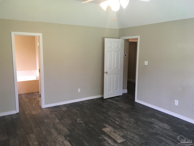 unfurnished bedroom featuring baseboards and dark wood-style floors