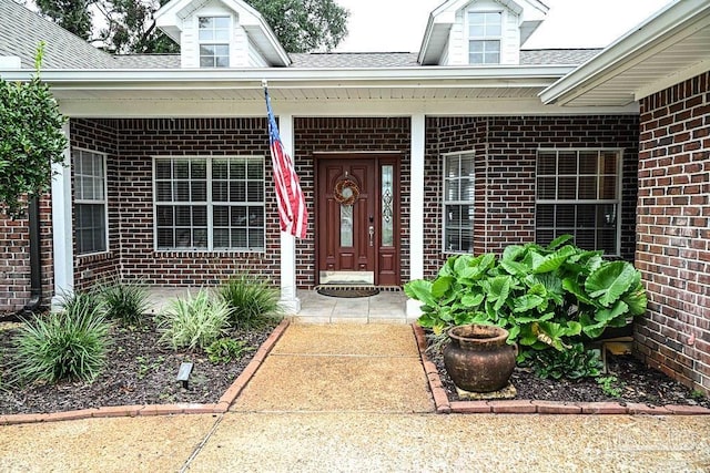 view of exterior entry featuring a porch