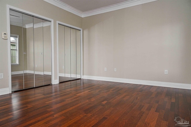 unfurnished bedroom featuring two closets, dark wood-type flooring, and crown molding