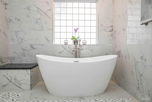 bathroom featuring tile walls and a bath