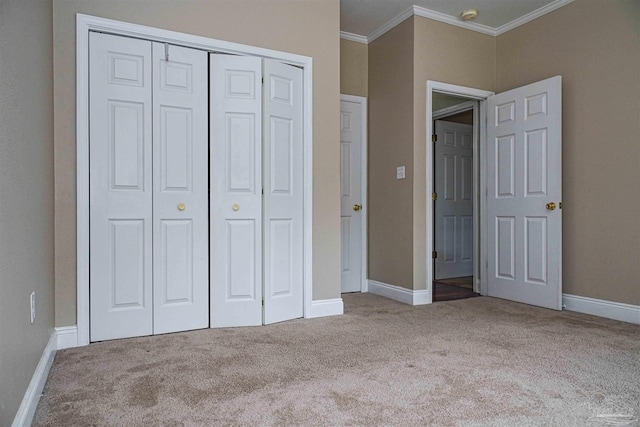 unfurnished bedroom with light carpet, a closet, and crown molding