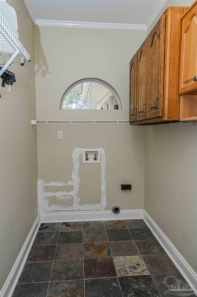 clothes washing area featuring hookup for a washing machine, ornamental molding, and cabinets