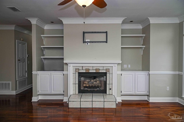 unfurnished living room featuring crown molding, a fireplace, dark hardwood / wood-style floors, and ceiling fan