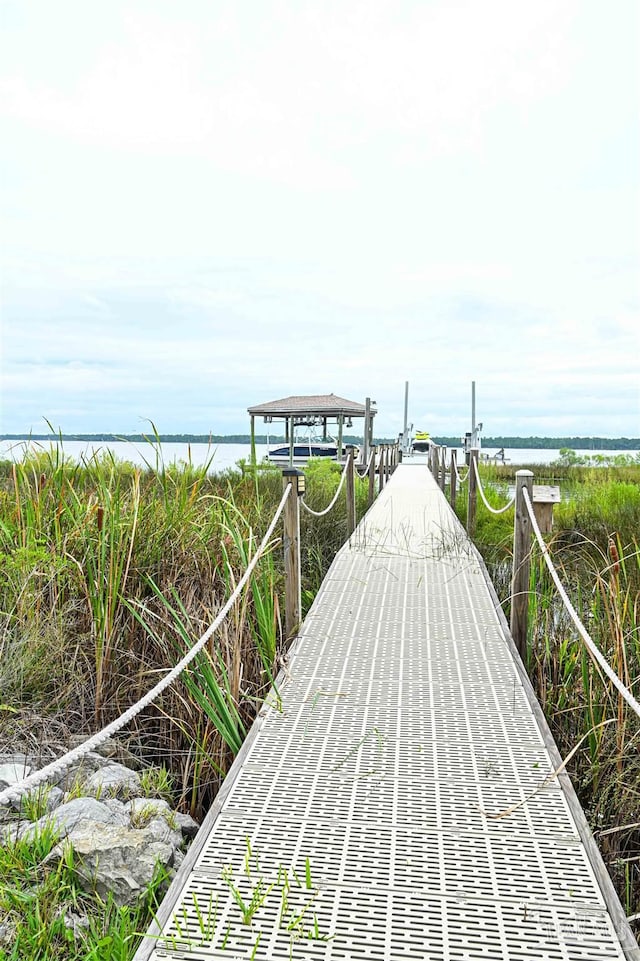 exterior space featuring a dock and a water view