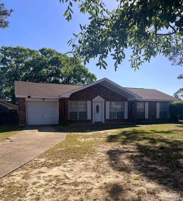 single story home with brick siding, an attached garage, driveway, and a front lawn