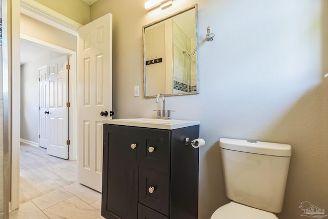 bathroom featuring toilet and vanity