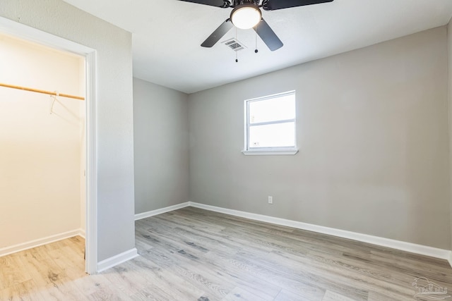 unfurnished bedroom with light wood finished floors, baseboards, and a ceiling fan