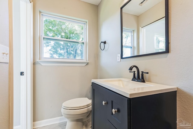 bathroom featuring toilet and vanity