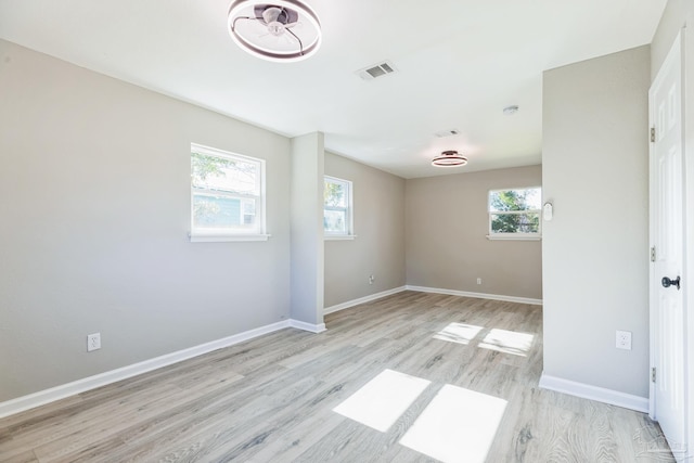 spare room with light wood finished floors and baseboards