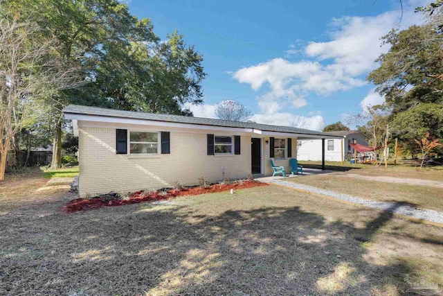 view of front of home with brick siding and a carport