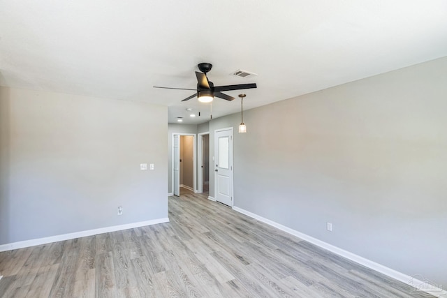unfurnished room featuring ceiling fan, light wood-style flooring, and baseboards