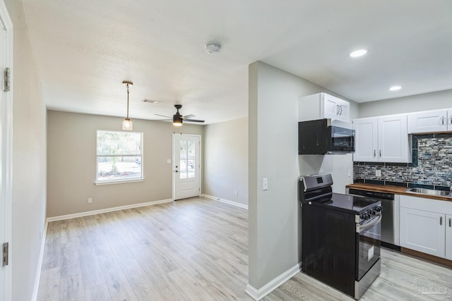 kitchen with range with electric stovetop, white cabinets, tasteful backsplash, light wood finished floors, and ceiling fan