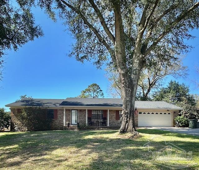 ranch-style house with a front lawn and a garage