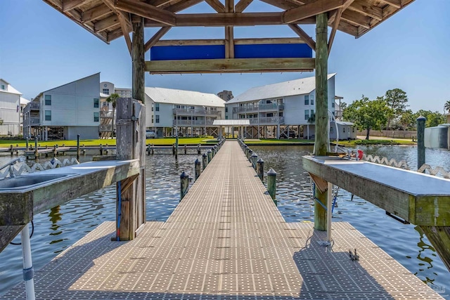 dock area with a residential view and a water view